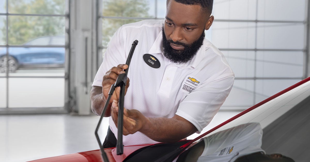 Chevy service technician inspecting wiper blades
