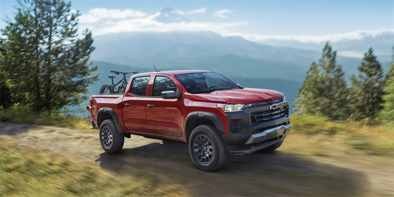 Trail Boss Chevrolet Colorado Truck driving uphill in rough terrain