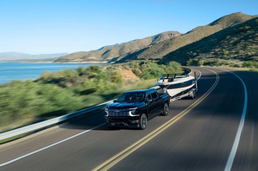 2027 Chevrolet Silverado 1500 towing a large boat showcasing its Engine and Powertrain Performance